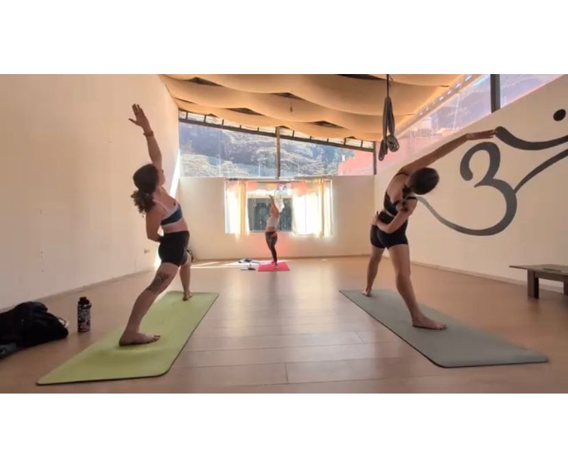 Sky teaching a group yoga class